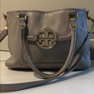 Tory Burch gray leather handbag with gold accents.